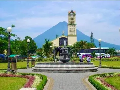 a fountain and a clock tower in a park at Villas Töcu-Casa Perezoso in Fortuna