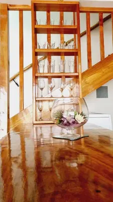 a room with a shelf with glasses and a bowl of flowers at Villas Flakis, Luna in Monteverde Costa Rica