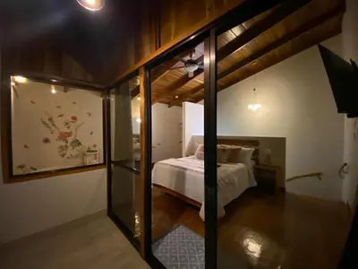 a bedroom with a bed in a room at Villas Flakis, Luna in Monteverde Costa Rica