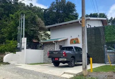 a black truck parked in front of a house at Villas Flakis, Luna in Monteverde Costa Rica