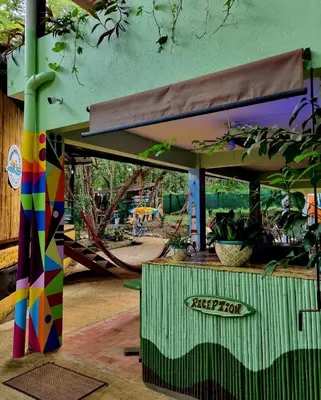 a playground with a colorful play structure with a slide at Casa Pura Vida Surf Hostel - Tamarindo Costa Rica in Tamarindo