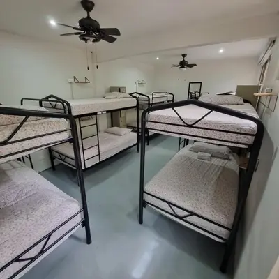 a group of four bunk beds in a room at Casa Pura Vida Surf Hostel - Tamarindo Costa Rica in Tamarindo