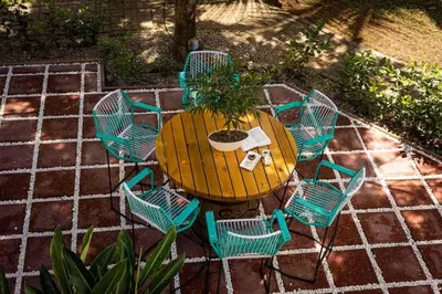 a table and chairs with a potted plant on it at Condo Pacifico in Quepos