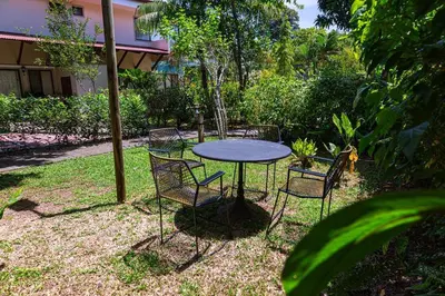 a table and chairs sitting in a yard at Condo Pacifico in Quepos