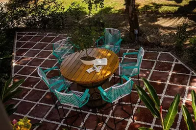 a wooden table with chairs around it on a patio at Condo Pacifico in Quepos