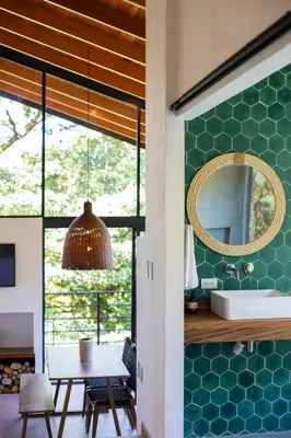 a dining room with a mirror and a table at Casas Jaguar in Monteverde Costa Rica