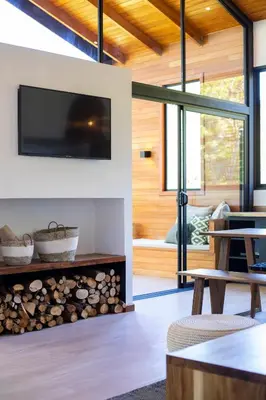 a living room with a fireplace and a tv on a wall at Casas Jaguar in Monteverde Costa Rica