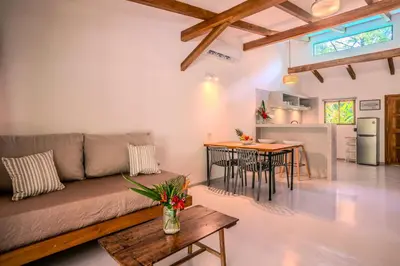 a living room with a couch and a table at Feeling Trees Jungle Lodge in Cabuya