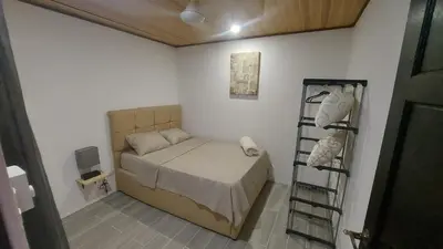 a small bedroom with a bed in a room at Casa Dñ Ana in Jacó