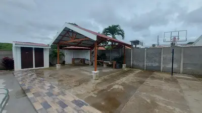 a building with a pavilion in a parking lot at Casa Dñ Ana in Jacó