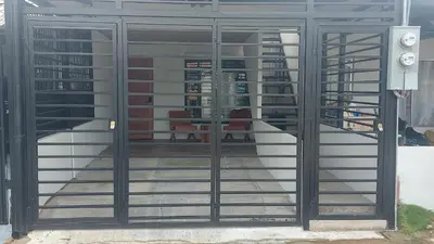 a door with glass panels on the side of a building at Casa Dñ Ana in Jacó