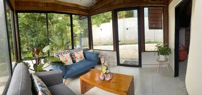 a living room with a blue couch and a table at Cabaña de Montaña Flaki's in Monteverde Costa Rica
