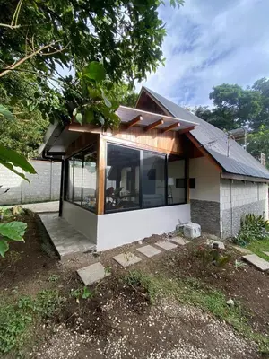 a house with a large window on the side of it at Cabaña de Montaña Flaki's in Monteverde Costa Rica