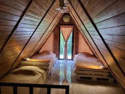 a bedroom with two beds in a attic at Cabañas Los Jobos in Villarreal