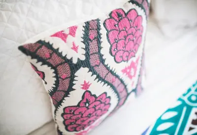 a pillow sitting on top of a bed at Encantada Ocean Cottages in Esterillos Este