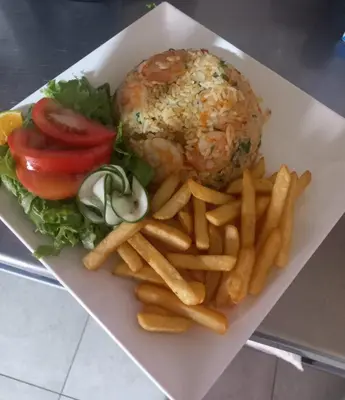 a plate of food with a burger and french fries at HOTEL Y RESTAURANTE RANCHO DE SEBAS in Nicoya