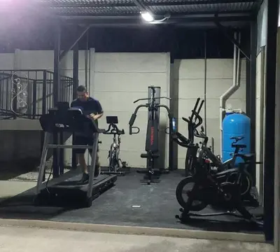 a man in a gym with two exercise bikes at HOTEL Y RESTAURANTE RANCHO DE SEBAS in Nicoya