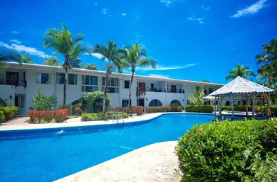 a swimming pool in front of a building at Cozy getaway w/pool-tennis-bbq near Manuel Antonio in Manuel Antonio