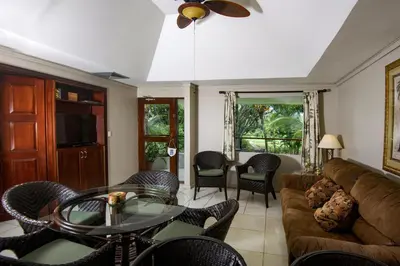 a living room with a couch and a table and chairs at Cozy getaway w/pool-tennis-bbq near Manuel Antonio in Manuel Antonio