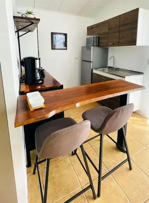 a kitchen with a wooden table and two chairs at Casa Bambu céntrico, lindo y acogedor con A C in General Viejo