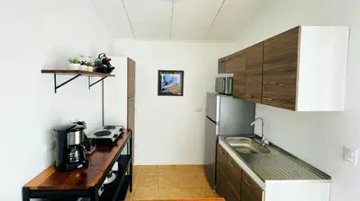 a small kitchen with a counter and a refrigerator at Casa Bambu céntrico, lindo y acogedor con A C in General Viejo