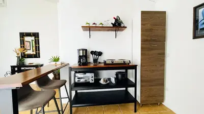 a kitchen with a counter and a table and chairs at Casa Bambu céntrico, lindo y acogedor con A C in General Viejo
