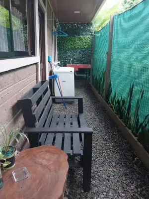 a bench sitting on a porch next to a table at The Bees House in Fortuna
