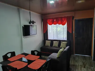 a living room with a table and a couch at The Bees House in Fortuna