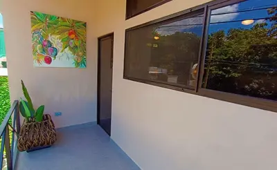 a hallway with a window and a plant next to it at Suite Dream Blue in Tamarindo