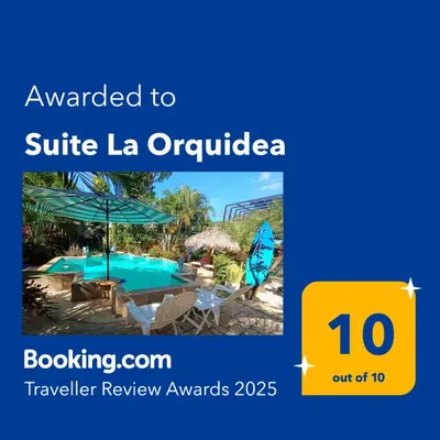 a sign that reads awarded to suite la orchidia a resort with a pool at Suite La Orquidea in Tamarindo