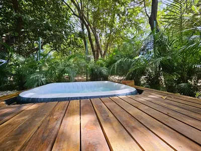 a hot tub sitting on top of a wooden deck at CasaBus beautiful bus dept. 50m from beach in Santa Cruz