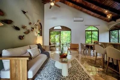 a living room with a couch and a table at The Garden Casitas by Vista Celestial in Uvita