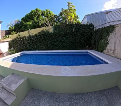 a small swimming pool in the backyard of a house at Habitación Privada Economica con baño compartido in Brasilito