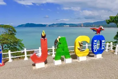 a group of colorful figurines sitting next to a fence at Condo en Jacó in Jacó