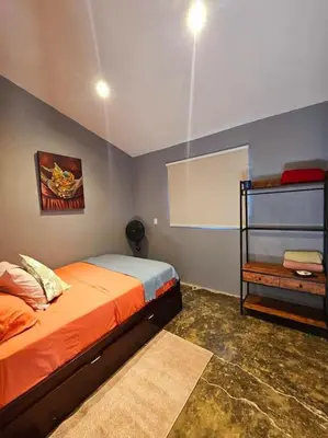a bedroom with a bed and a chalkboard on the wall at Casa Cariad Close to surfing lessons and more! in Parrita