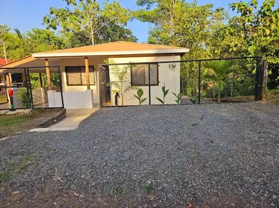 a small house with a fence in front of it at Casa Cariad Close to surfing lessons and more! in Parrita