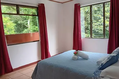 a bedroom with a teddy bear sitting on a bed at Globi Lodge #5 in Monteverde Costa Rica