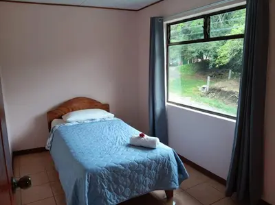 a bedroom with a bed and a window at Globi Lodge #5 in Monteverde Costa Rica
