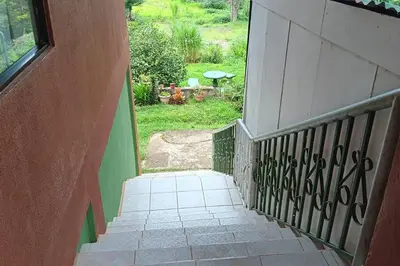 a stairway leading up to a house with a yard at Globi Lodge #5 in Monteverde Costa Rica
