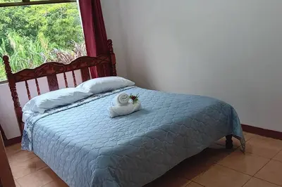 a bedroom with a bed with a towel on it at Globi Lodge #5 in Monteverde Costa Rica
