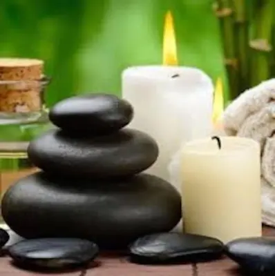 a stack of black rocks next to a candle at Casa Montaña & Spa Pital de San Carlos Costa Rica in Pital