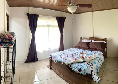 a bedroom with a bed and a ceiling fan at Casa Montaña & Spa Pital de San Carlos Costa Rica in Pital