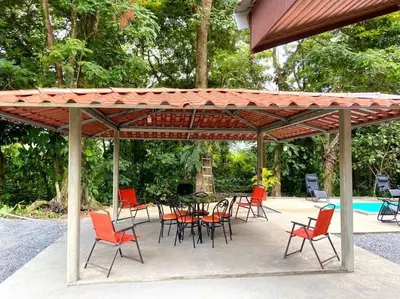 a patio with a table and chairs under a pavilion at Casa Montaña & Spa Pital de San Carlos Costa Rica in Pital