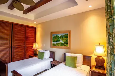two beds in a room with two lamps at Spacious 2BR Condo with Ocean Glimpse - Jobo - Reserva Conchal Golf Resort in Playa Conchal