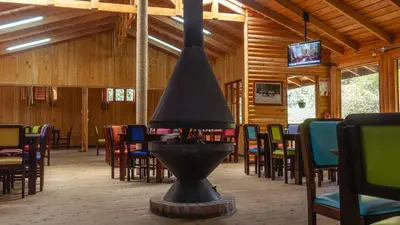 a dining room with a fire hydrant and tables and chairs at Hacienda La Lucha in Lucha