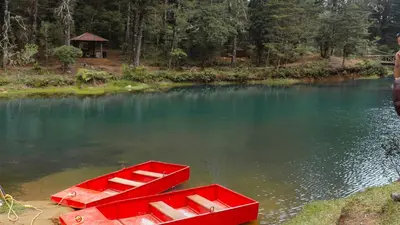 a red boat sitting in the middle of a lake at Hacienda La Lucha in Lucha