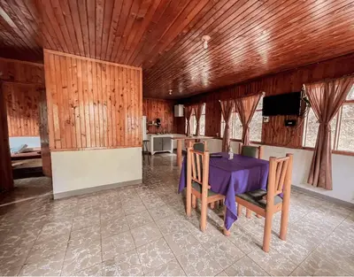 a dining room with a purple table and chairs at Hacienda La Lucha in Lucha