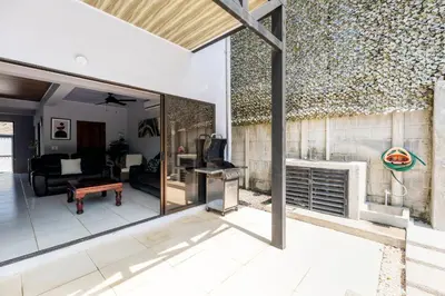 a living room with a fireplace and a couch at Private home with resort style swimming pool in Jacó