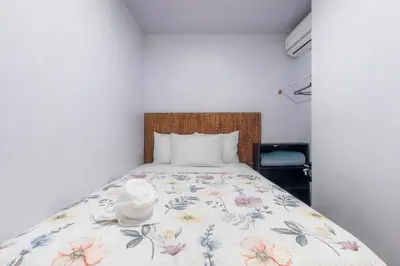 a bedroom with a bed with a floral bedspread at Private home with resort style swimming pool in Jacó