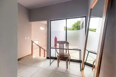 a dining room with a glass table and a chair at Private home with resort style swimming pool in Jacó